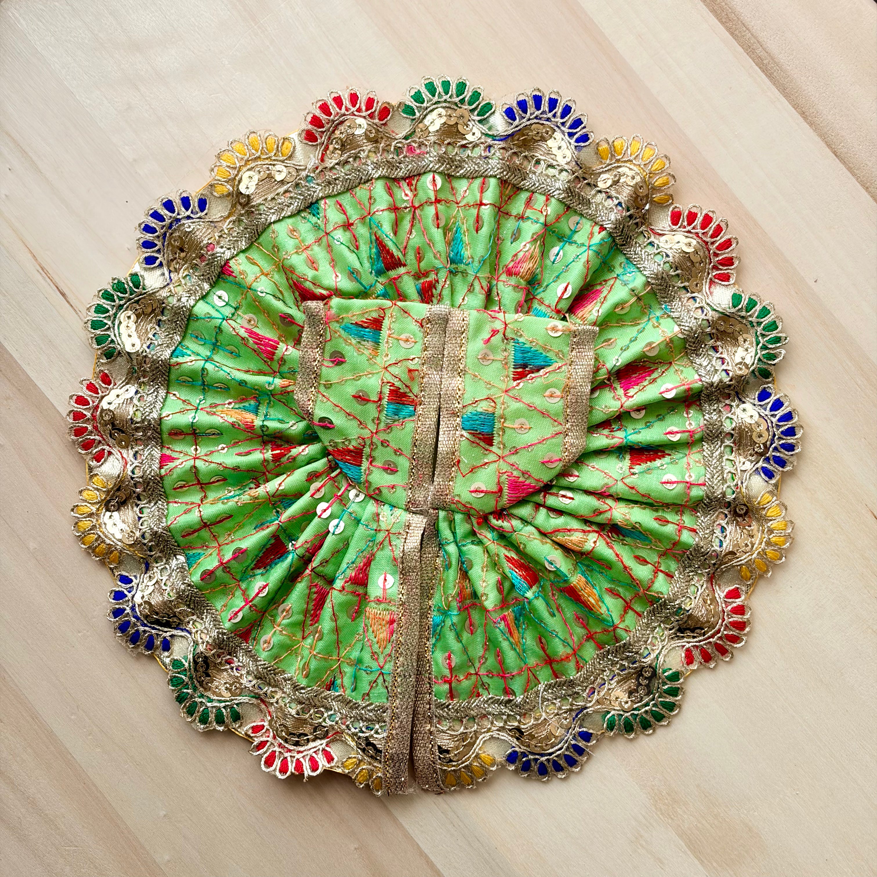 Multi colour border and green base Laddu Gopal dress for festive shringar in premium fabric with decorative detailing